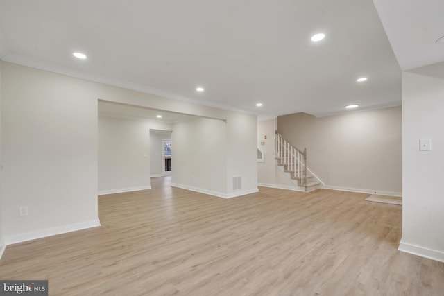 interior space with light wood-type flooring and crown molding