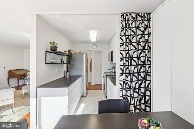 kitchen featuring white cabinets and appliances with stainless steel finishes