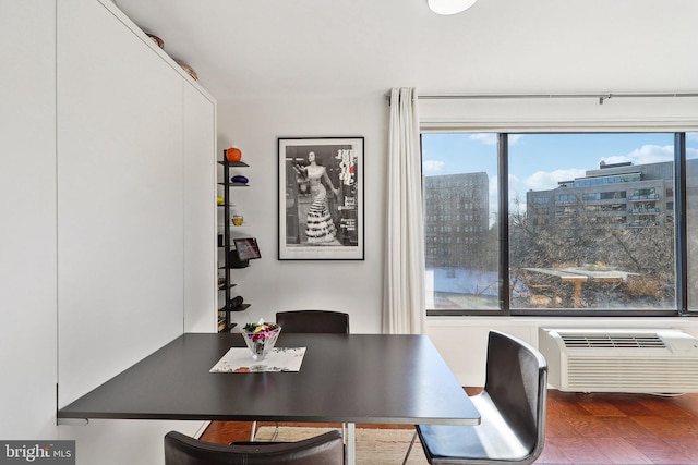 dining room featuring hardwood / wood-style flooring and a wall mounted AC