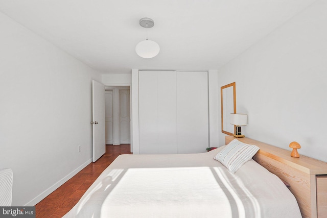 bedroom featuring a closet and dark wood-type flooring