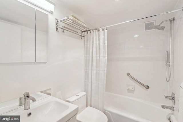 full bathroom featuring shower / bath combination with curtain, vanity, and toilet