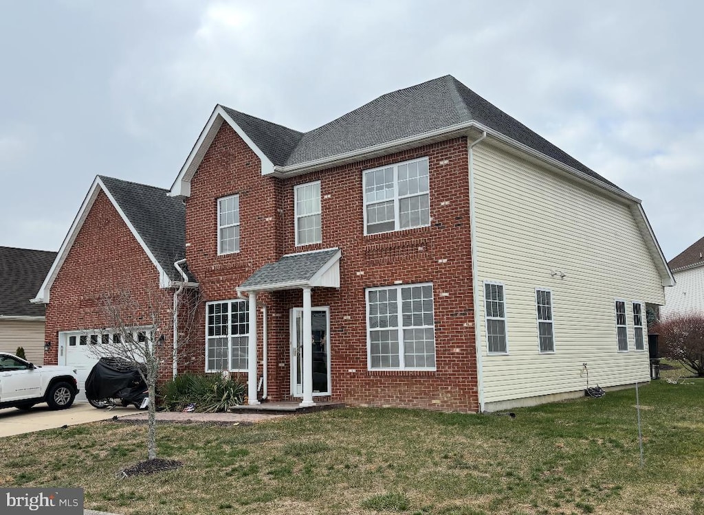 view of front of home with a front lawn and a garage