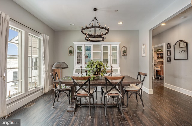 dining space featuring dark hardwood / wood-style flooring and a notable chandelier