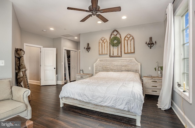 bedroom with ceiling fan, dark wood-type flooring, and a closet