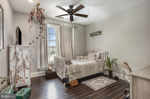 bedroom with dark hardwood / wood-style floors and ceiling fan