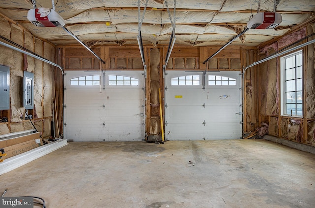 garage with electric panel and a garage door opener