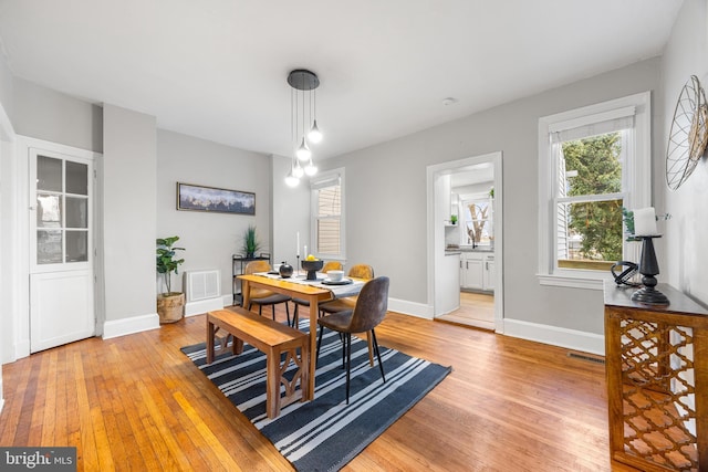 dining space with light hardwood / wood-style floors