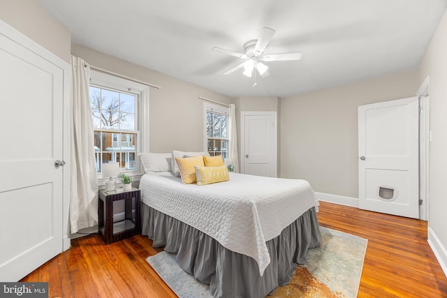 bedroom with ceiling fan and hardwood / wood-style flooring