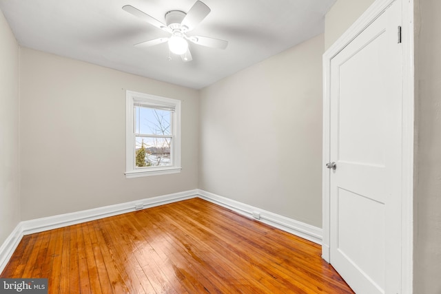 unfurnished room featuring ceiling fan and hardwood / wood-style floors