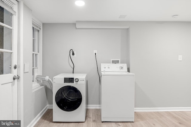 washroom featuring light hardwood / wood-style flooring and washing machine and dryer