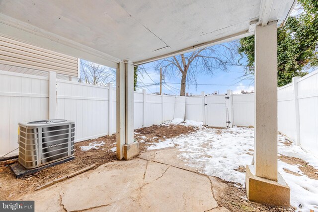 snow covered patio featuring central AC