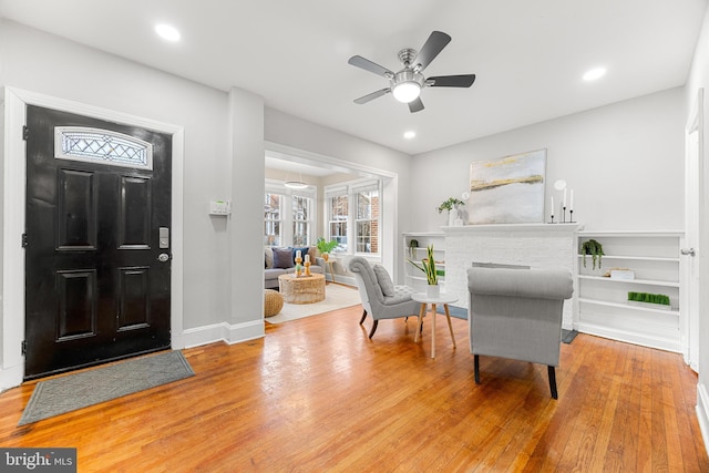 entryway with ceiling fan and wood-type flooring