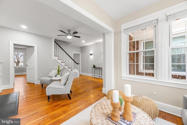 living area featuring ceiling fan and hardwood / wood-style floors