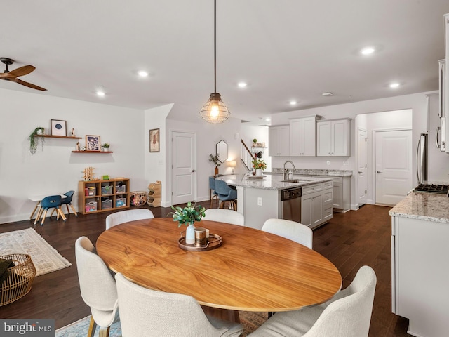 dining room with ceiling fan, dark hardwood / wood-style flooring, and sink