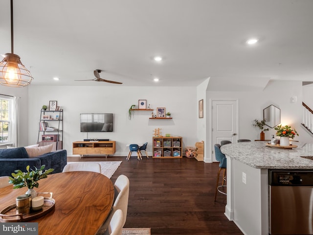 dining area featuring ceiling fan and dark wood-type flooring