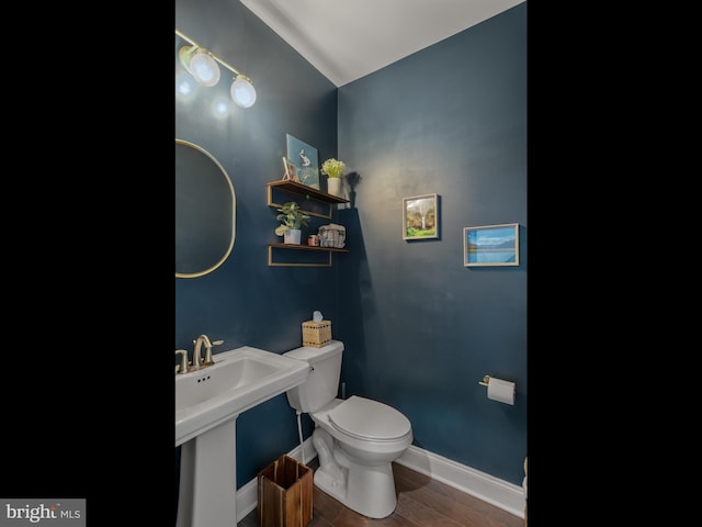 bathroom featuring hardwood / wood-style flooring, toilet, and sink