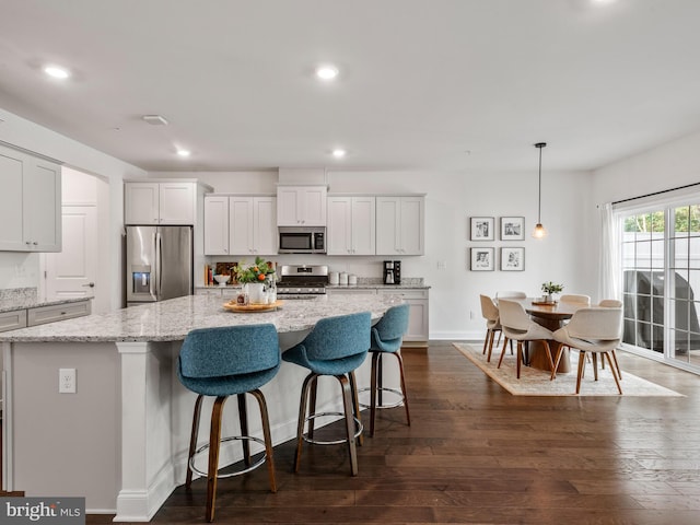 kitchen featuring white cabinets, stainless steel appliances, and a kitchen island