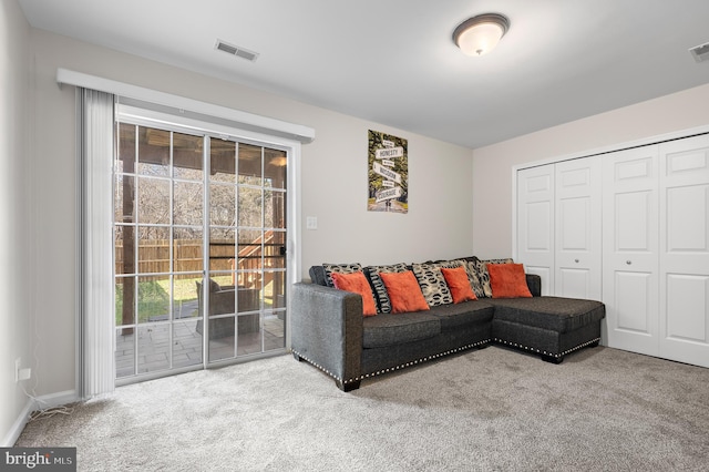 living room with carpet flooring and visible vents