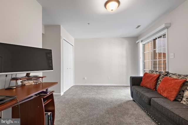 carpeted living room with visible vents and baseboards