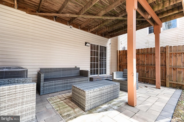 view of patio featuring an outdoor living space, central AC, and fence