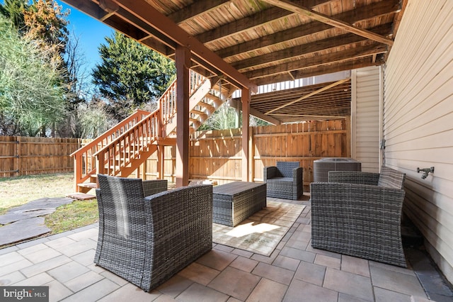 view of patio / terrace with cooling unit, a fenced backyard, and stairs