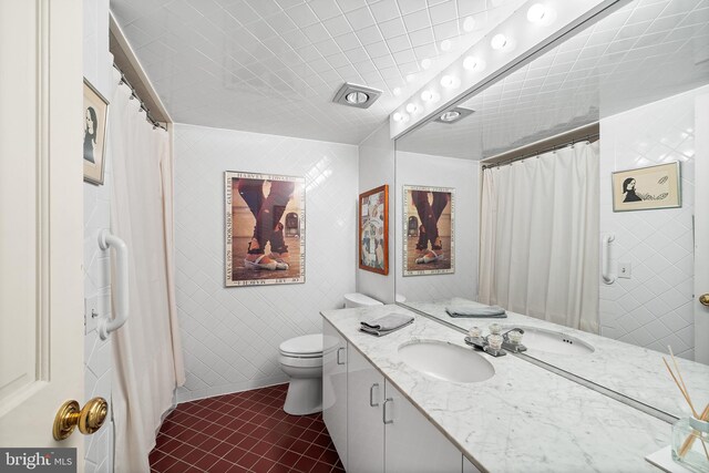 bathroom featuring toilet, walk in shower, and vanity