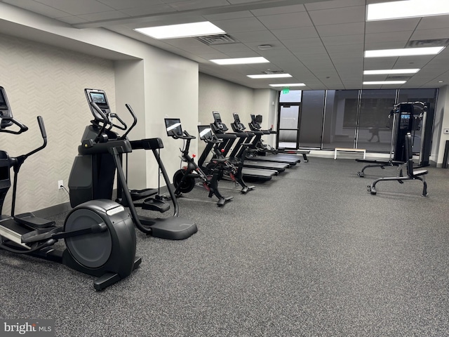 exercise room featuring a drop ceiling