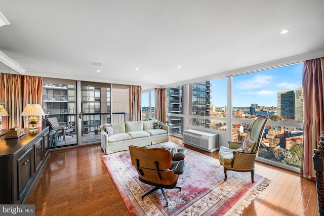 living room with floor to ceiling windows, crown molding, and hardwood / wood-style floors