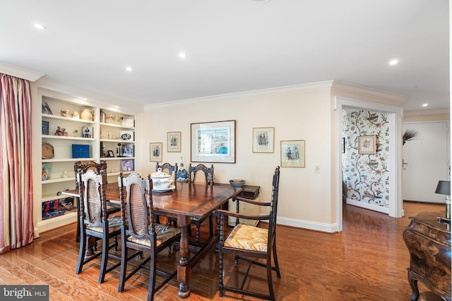 dining space with built in features, ornamental molding, and hardwood / wood-style floors