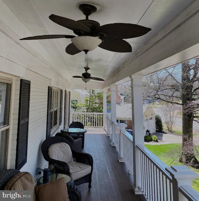 deck featuring covered porch and ceiling fan