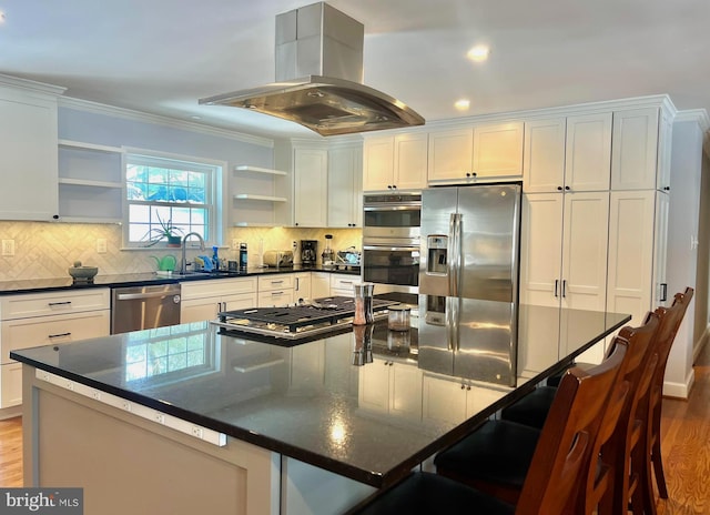 kitchen featuring a center island, sink, appliances with stainless steel finishes, white cabinets, and island exhaust hood