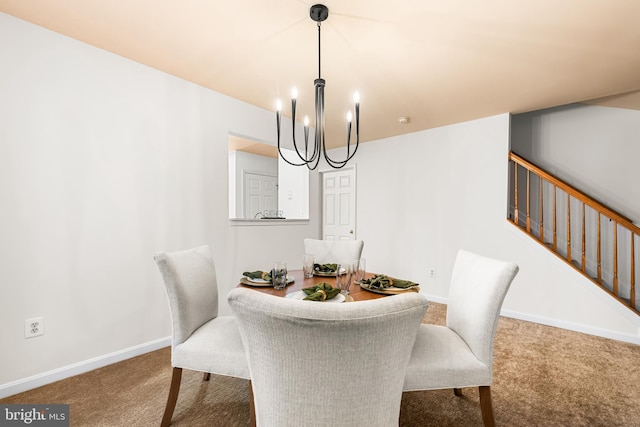 dining space featuring a notable chandelier and carpet flooring