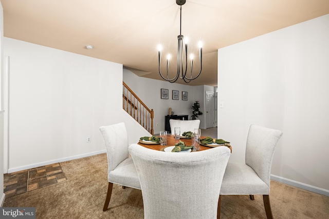 dining area with an inviting chandelier and light colored carpet