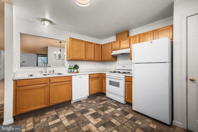 kitchen featuring a notable chandelier, sink, pendant lighting, and white appliances