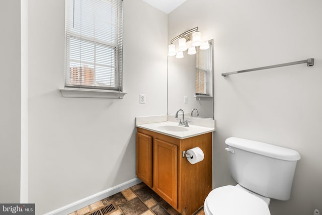 bathroom featuring toilet and vanity