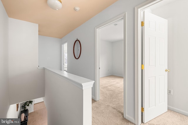 hallway with light colored carpet