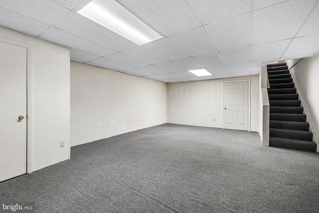 basement featuring carpet flooring and a drop ceiling