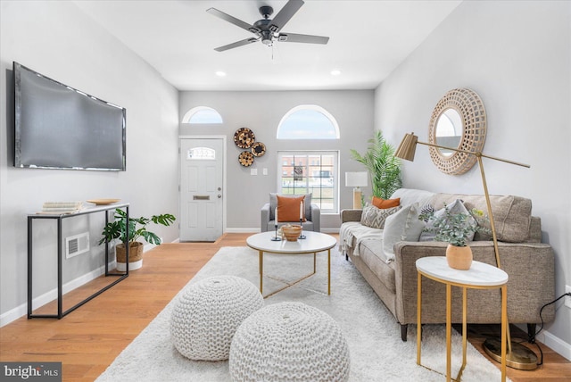 living room with ceiling fan and light wood-type flooring