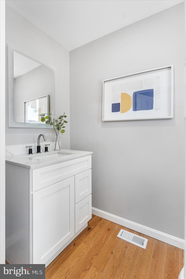 bathroom featuring hardwood / wood-style flooring and vanity