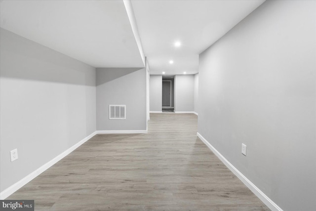 corridor with light hardwood / wood-style floors