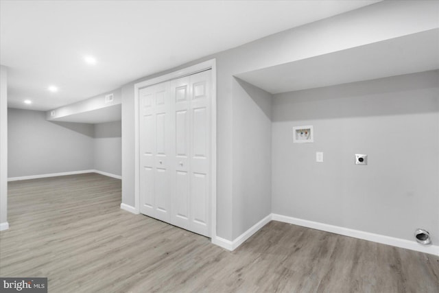 interior space with hookup for an electric dryer, light wood-type flooring, and hookup for a washing machine