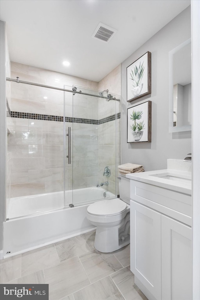 full bathroom featuring tile patterned flooring, toilet, vanity, and combined bath / shower with glass door