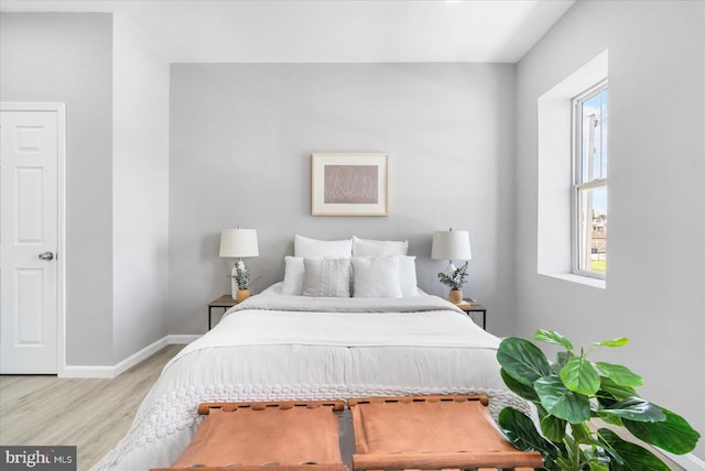 bedroom featuring light hardwood / wood-style flooring and multiple windows