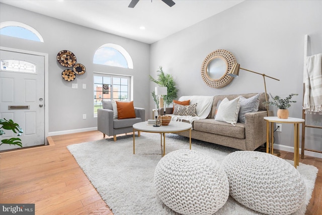 living room featuring ceiling fan and hardwood / wood-style floors