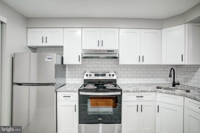 kitchen with white cabinets, appliances with stainless steel finishes, backsplash, and sink