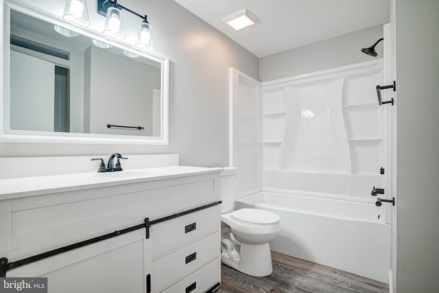 full bathroom featuring vanity, hardwood / wood-style flooring, toilet, and tub / shower combination