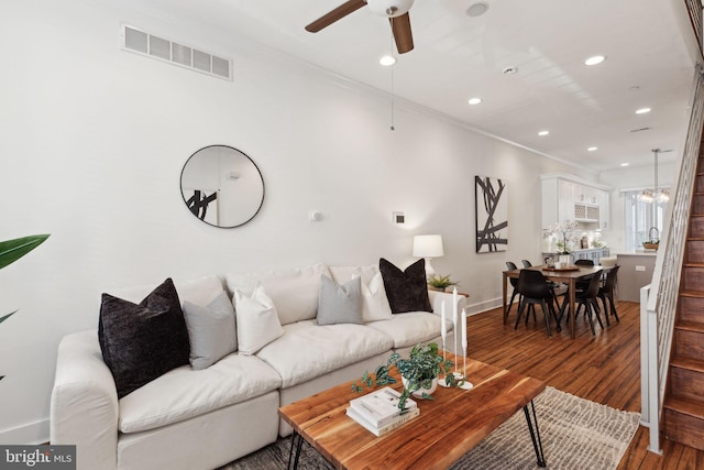 living room with ceiling fan, ornamental molding, and hardwood / wood-style flooring