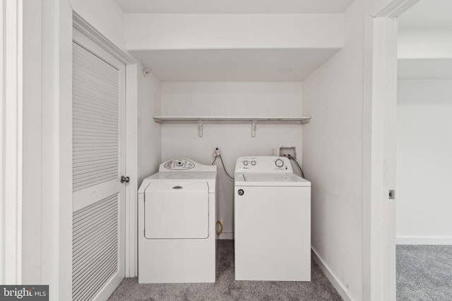 clothes washing area with washer and clothes dryer and carpet floors