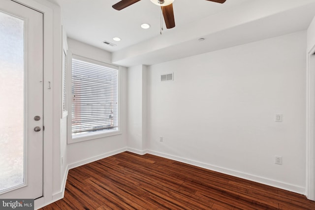 unfurnished room with dark wood-type flooring