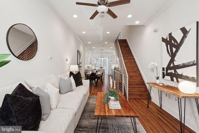 living room featuring ceiling fan, dark hardwood / wood-style flooring, and crown molding